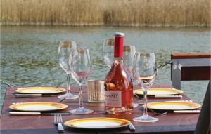 a table with wine glasses and a bottle of wine at Hafen Loitz in Loitz