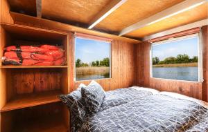 a bedroom with a bed and two windows at Hafen Loitz in Loitz