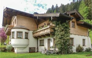 a large wooden house with a table in front of it at Cozy Apartment In Wagrain With Kitchen in Wagrain