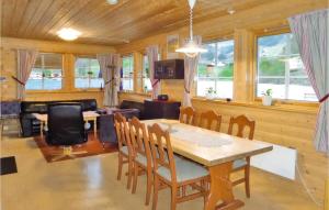 a dining room with a table and chairs and a couch at Gorgeous Home In Åkra With Wifi in Åkra +12 photos