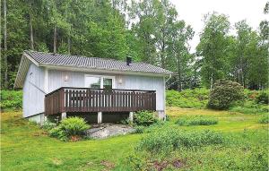 a small house with a deck in a field at Lovely Home In Fjrs With House Sea View in Vågerse