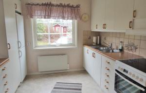 a small kitchen with a sink and a window at Lovely Home In Fjrs With House Sea View in Vågerse