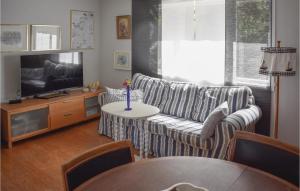 een woonkamer met een bank en een tafel bij Cozy Home In Djurhamn With Wifi in Djurhamn