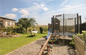 a playground in a garden with a trampoline at Cozy Apartment In Karlshausen With Wifi in Karlshausen