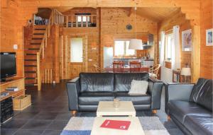 a living room with leather couches and a tv at 3 Bedroom Cozy Home In Sint-Annaland in Sint Annaland