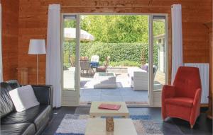 a living room with a couch and chairs and a patio at 3 Bedroom Cozy Home In Sint-Annaland in Sint Annaland