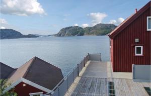 a red building next to a large body of water at Nice Apartment In Korshamn With 3 Bedrooms And Wifi in Korshamn