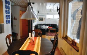 a dining room with a table and a couch at Amazing home in Sparreholm with 5 Bedrooms, Sauna and WiFi in Sparreholm