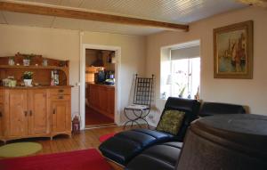 a living room with a couch and a kitchen at Awesome Home In Ystad With 2 Bedrooms And Wifi in Svarte