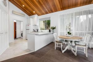 a kitchen and dining room with a table and chairs at Sails Five Inverloch in Inverloch