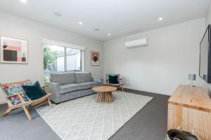 a living room with a couch and a table at Inverloch Oasis L Oasi de Invy in Inverloch