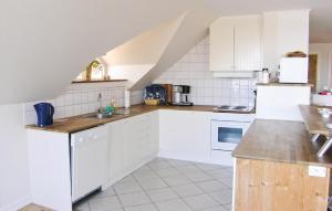 a kitchen with white cabinets and a counter top at Beautiful Home In Lidhult With Kitchen in Löckna +14 photos