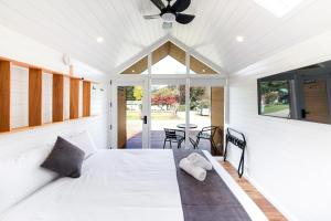 a bedroom with a bed and a ceiling fan at Bright Riverside Holiday Park in Bright