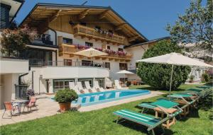 a villa with a swimming pool and patio furniture at Stunning Apartment In Wagrain With Wifi in Wagrain