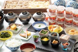 a table topped with different types of food and containers at Hotel The West Hills Mito in Mito