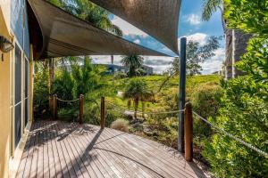 a wooden walkway leading to a house with a view of a garden at Beachy Haven at Sails close to the Beach in Inverloch