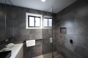 a bathroom with a shower and a sink and a window at Bright Riverside Holiday Park in Bright