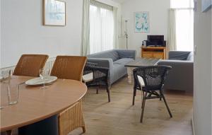 - un salon avec des tables, des chaises et un canapé dans l'établissement Cozy Home In Tzummarum With Outdoor Swimming Pool, à Tzummarum
