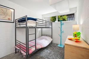 a bedroom with a bunk bed and a desk with a lamp at 1 Luana in Lorne
