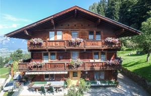 a large wooden house with flowers on the balcony at Schoenes Ferienhaus Zillertal in Hart im Zillertal +15 photos