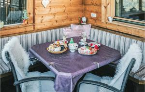 a purple table with food on it on a porch at Schoenes Ferienhaus Zillertal in Hart im Zillertal