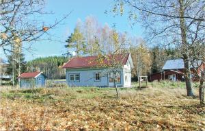 a blue house in the middle of a field at Holiday Home Östra Berga Lysvik in Lysvik