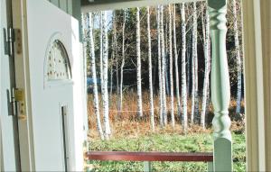 a window view of a forest of aspen trees at Holiday Home Östra Berga Lysvik in Lysvik
