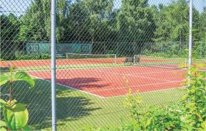 a tennis court with two tennis courts at 3 Bedroom Awesome Home In Vlagtwedde in Vlagtwedde