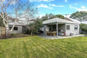 a white house with a patio and a yard at Ripple Dream Inverloch in Inverloch