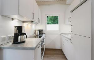 a kitchen with white appliances and a window at Ferienhausdorf Thale in Thale
