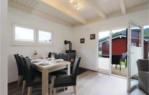 a dining room with a wooden table and black chairs at Ferienhausdorf Thale in Thale