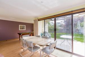 a dining room with a table and chairs at Holiday on Nautilus Inverloch in Inverloch