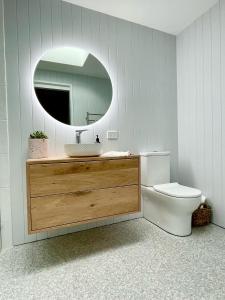 a bathroom with a sink and a toilet and a mirror at Hip Nautic 100 Metres to Beach in Inverloch