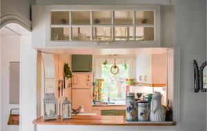 a kitchen with white cabinets and a counter top at Holiday Home Yngsjö 49 in Yngsjö