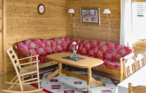 a living room with a red couch and a table at Beautiful Home In Fister With Wifi in Fister