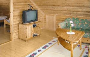 a living room with a tv and a table at Beautiful Home In Fister With Wifi in Fister