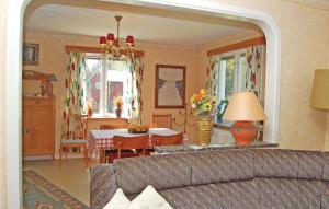 a living room with a couch and a dining room at Holiday Home Tosthult Lönsboda Lönsboda in Falsehult