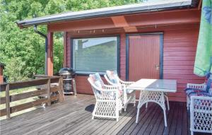 a deck with a table and chairs and a grill at Amazing Home In Saltnes With Wifi in Saltnes
