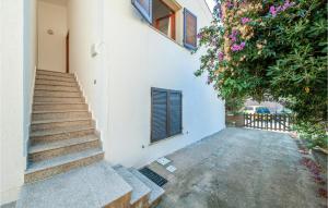 a stairway next to a white building with flowers at Trilo Sup in Isola Rossa