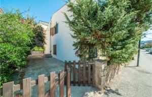 a wooden fence in front of a white building at Trilo Sup in Isola Rossa