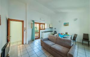 a living room with a couch and a kitchen at Trilo Sup in Isola Rossa +12 photos