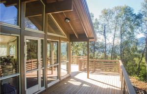a house with a wrap around porch with a view of the woods at Lovely Home In Stranda With House A Mountain View in Stranda