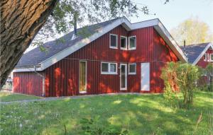 a red barn with a white door at 3 Bedroom Gorgeous Home In Rechlin in Rechlin