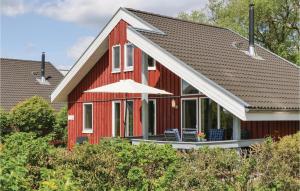 a red house with a black roof at 3 Bedroom Gorgeous Home In Rechlin in Rechlin