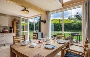a wooden table in a kitchen with a large window at Stunning Home In Zerpenschleuse With 2 Bedrooms And Wifi in Zerpenschleuse