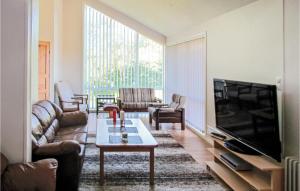 a living room with a couch and a tv at Nice Home In Kleppe With Wifi in Orre