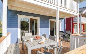una casa azul con patio con mesa y sillas en Seeteufel 6, en Süssau