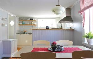 a kitchen and dining room with a table and chairs at Stunning home in Nssj with 3 Bedrooms and WiFi in Barkansjö