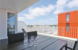 two wine glasses sitting on a wooden table on a balcony at Priwallpromenade 23, Whg 11 in Travemünde