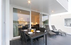 a patio with a table and chairs on a balcony at Priwallpromenade 23, Whg 11 in Travemünde